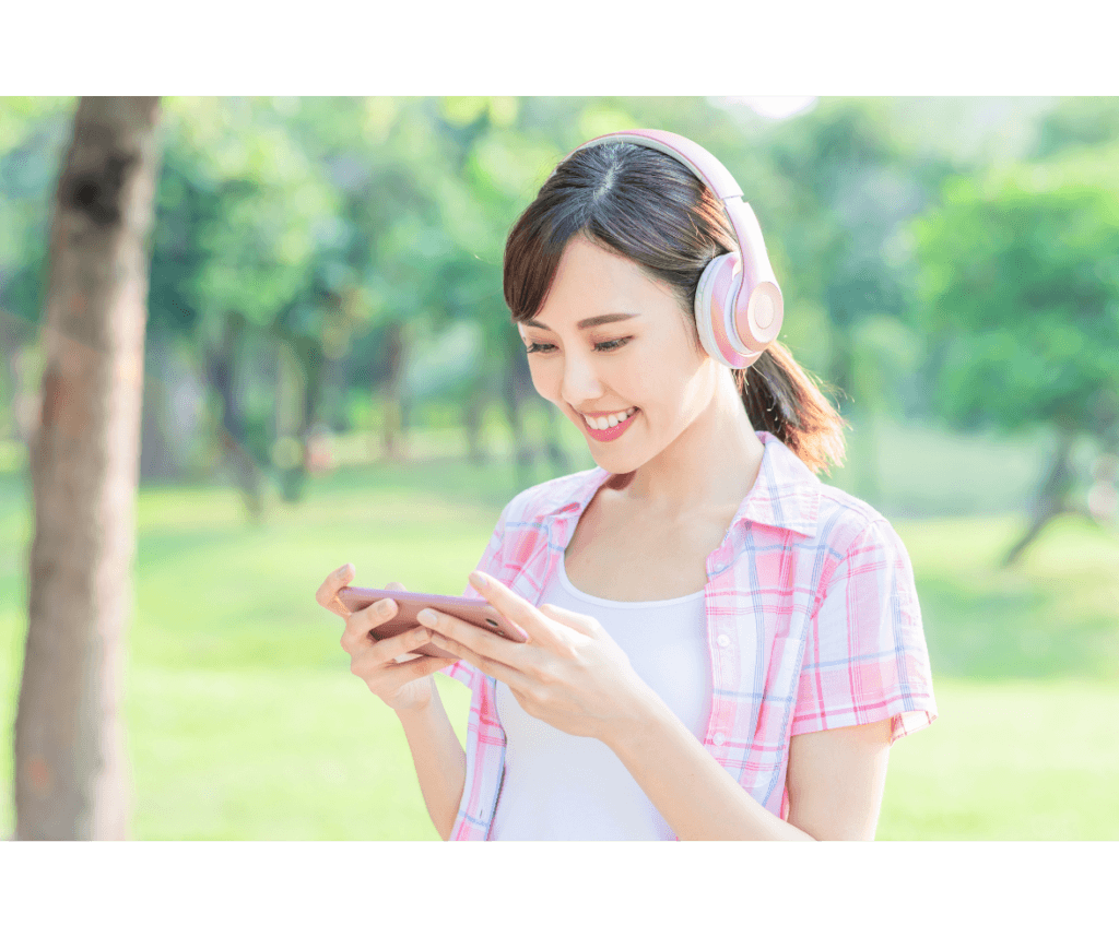 Woman watching a video on her phone in the cemetery.